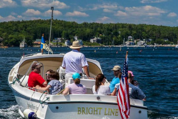 A group of people are on a boat named 