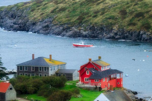 The image shows a coastal scene with colorful houses near the water, a red boat in the bay, and rocky hills in the background, ending the sentence.